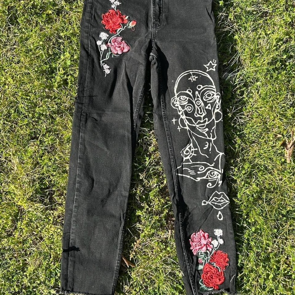 Custom black jeans with floral embroidery and hand done bleach design